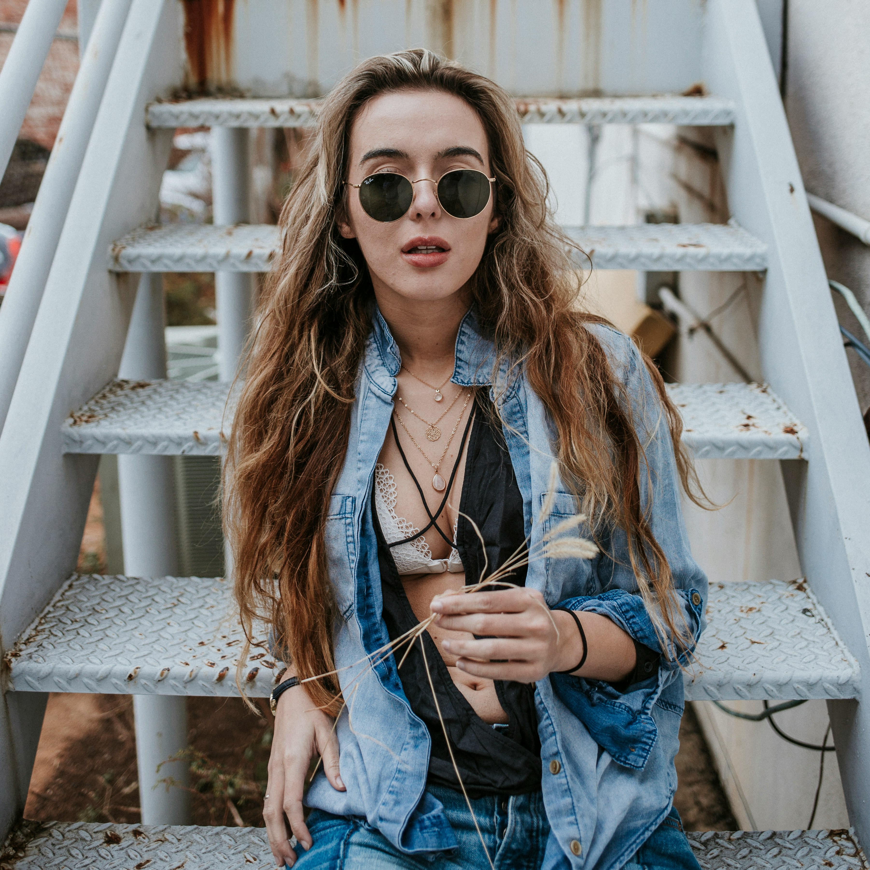 woman wearing black sunglasses on stairs